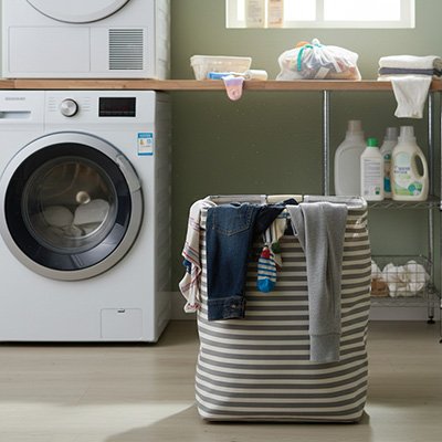 Panier a linge dans buanderie avec linge qui deborde
